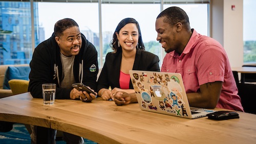 Image of colleagues viewing the Einstein AI Use Cases site