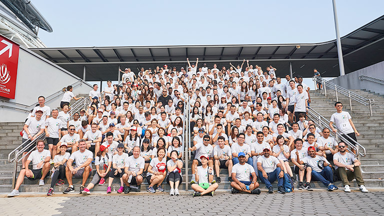 Singapore employees gathered together after raising money for charity