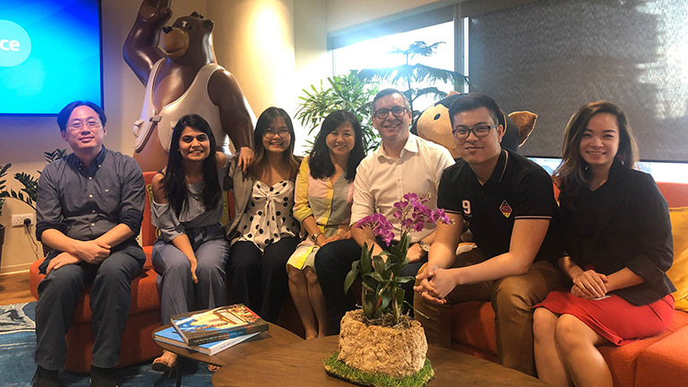 Paul posing for a photo with Cody and his Salesforce colleagues