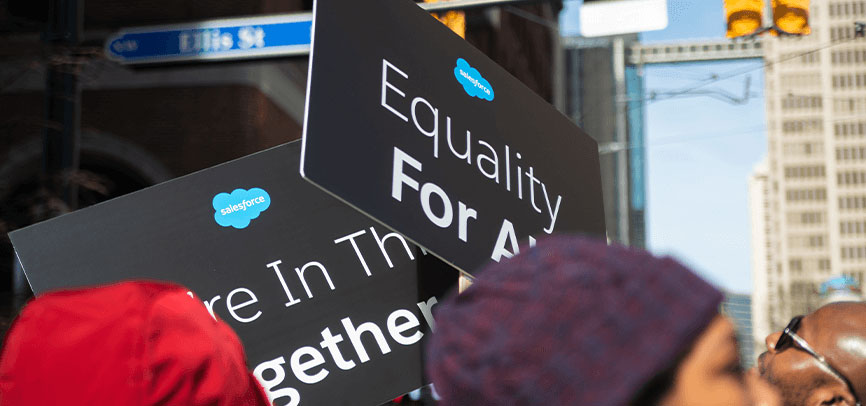 people marching holding equality for all signs