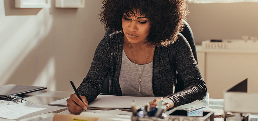 a black-owned business owner working at her desk