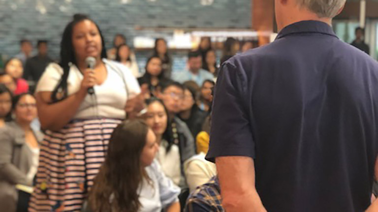 interns in a large group setting with a speaker