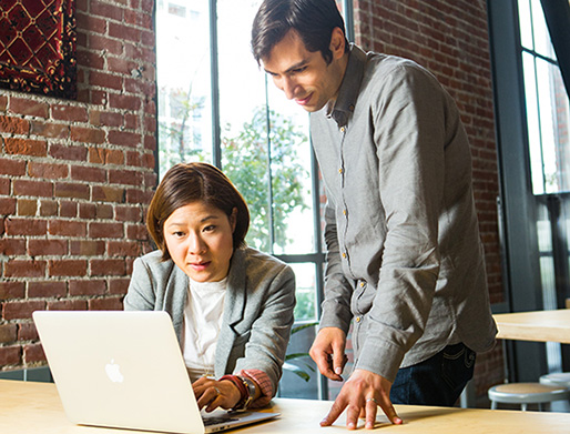 Man and woman looking at a laptop computer screen